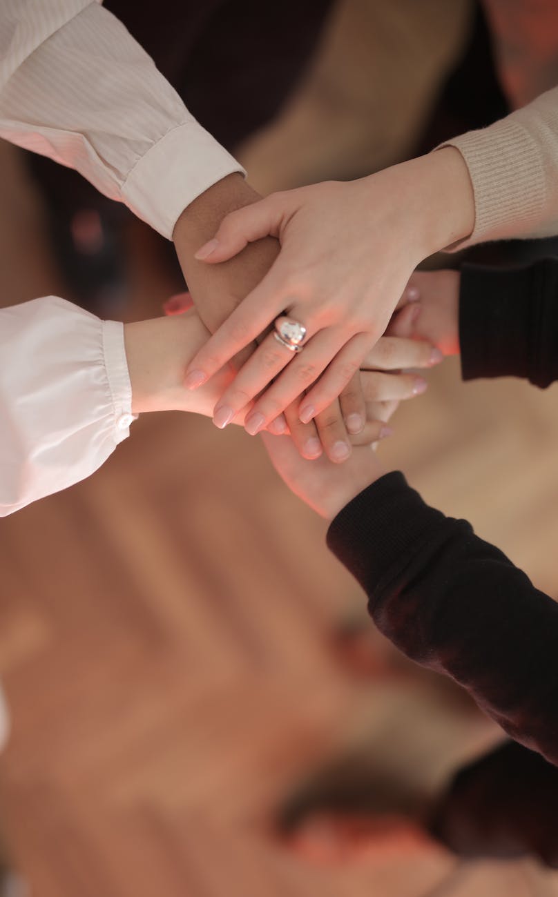 crop friends stacking hands together