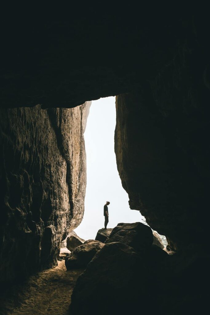 person standing on rock formation