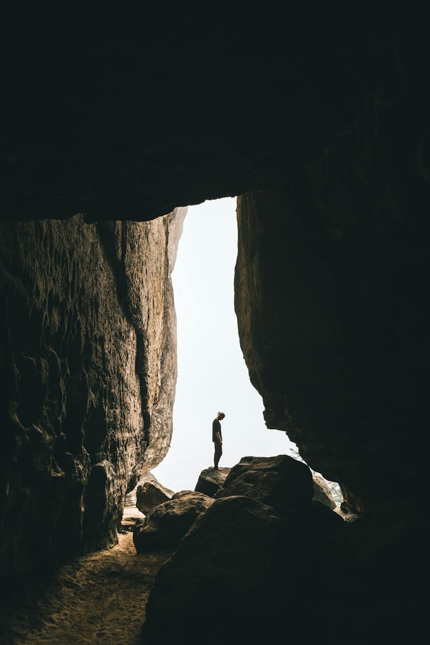 person standing on rock formation