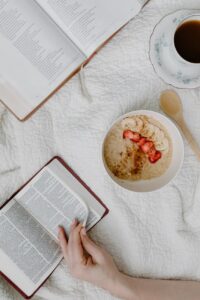 a person reading a book while having cereal